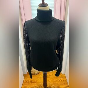 Black turtleneck sweater with sheer sleeves
